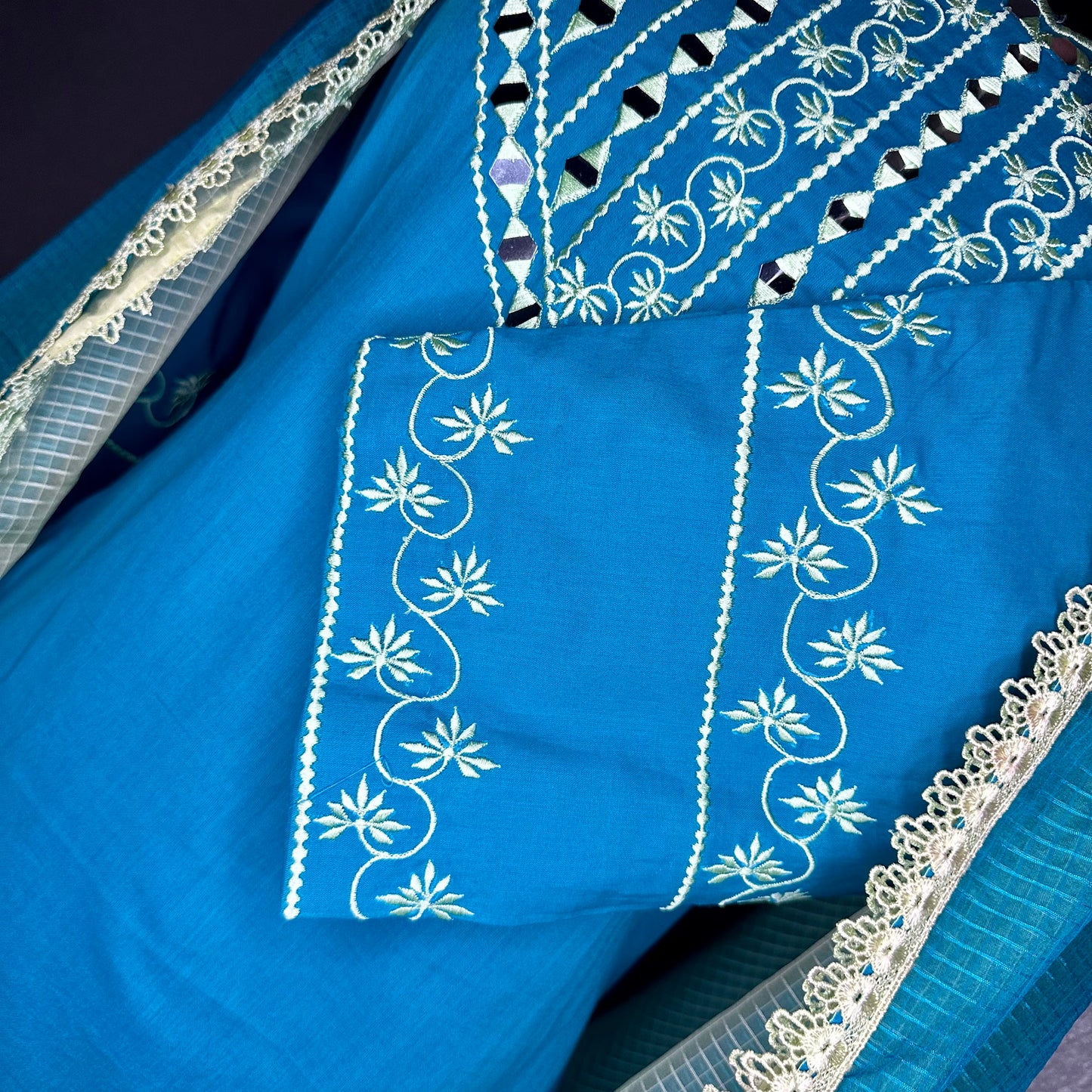 Very Elegant Turquoise Blue cotton suit with beautiful desined neck sleeves and bottom paired with a organza two toned dupatta and lacing